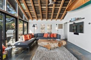 a living room with a couch and a table at Bodega Bay - Ocean View, Fireplace & BBQ in Bodega Bay