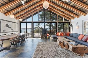 a living room with a blue couch and a table at Bodega Bay - Ocean View, Fireplace & BBQ in Bodega Bay