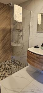 a bathroom with a shower and a sink at Cabana Valea Lupilor in Straja