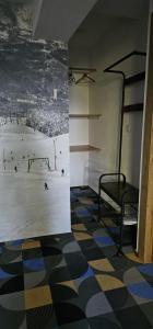 a room with a tennis match on the wall at Cabana Valea Lupilor in Straja