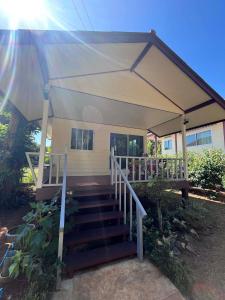a house with a porch with a white tent at Koh Mak Garden View for Family&Friends in Ko Mak