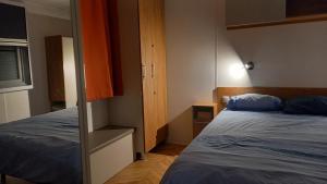 a small bedroom with a bed and a closet at Azur072 in Fréjus
