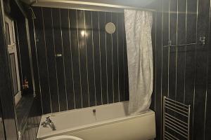a bathroom with a tub and a toilet and a shower at House-Sleeps 5 person -Etihad Stadium 15 min drive in Ashton under Lyne