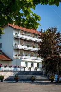 a white building with stairs in front of it at Hotel Bellevue in Kranj