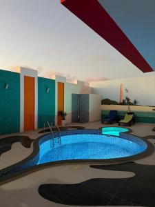 a swimming pool in the middle of a building at AQUÁRIO Apart Hotel in Sal Rei