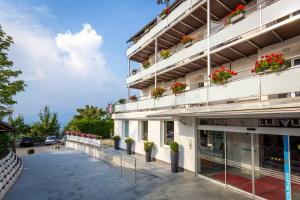 a facade of a hotel with potted plants on the balconies at Hotel Bellevue in Kranj