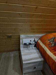 a bedroom with a bed with a wooden wall at A-frame , Quba Qecres in Qǝçrǝş +2 photos