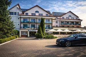 a car parked in front of a hotel at Best Western Silva Hotel in Sibiu