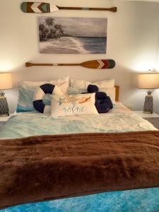 a bedroom with a bed with a surfboard on the wall at Pet friendly waterfront condo in Edgecomb