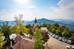 an aerial view of a church and a parking lot with cars at Hotel Bellevue in Kranj