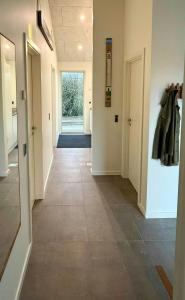 a hallway with a tile floor in a building at Architect-Designed House In Juelsminde in Juelsminde +14 photos