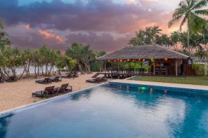 a resort with a pool and a bar on the beach at Arinna Beach Resort in Tangalle