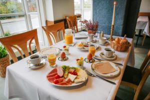 a table with a plate of breakfast food on it at Klindworths Gasthof in Sauensiek