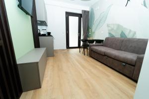 a living room with a couch and a table at Verdechiaro village in Roseto degli Abruzzi