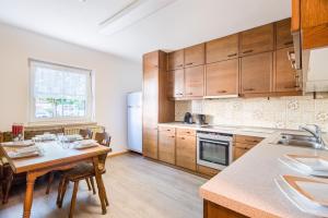 a kitchen with wooden cabinets and a table with chairs at WG-Pension in Landshut