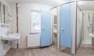 a bathroom with a glass shower and a sink at WG-Pension in Landshut