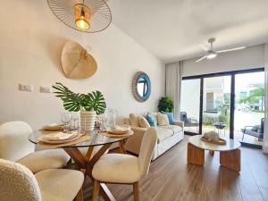 a living room with a table and chairs and a couch at Cana Cove in Punta Cana