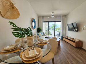 a dining room and living room with a table and chairs at Cana Cove in Punta Cana