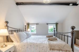a bedroom with a bed and two windows at 3 Bed in Alfrick oc-s32386 in Broadwas