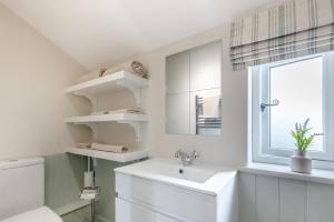 a white bathroom with a sink and a window at 3 Bed in Alfrick oc-s32386 in Broadwas +22 photos