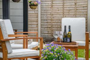 two chairs and a table with wine glasses and flowers at 3 Bed in Alfrick oc-s32386 in Broadwas