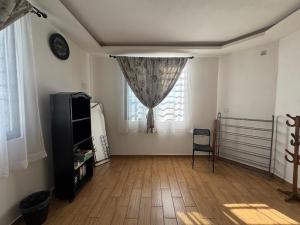 a living room with a table and a window at Casa Terraza Oaxaca in San Sebastián Etla