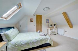 a white bedroom with a bed and a desk at 2 Bed in Lynton oc-chap in Lynmouth