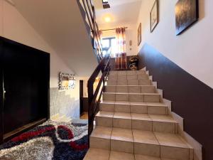 a staircase in a home with a blue wall at Alpenresidenz Viktoria in Türnitz