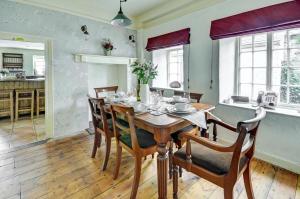 a dining room with a wooden table and chairs at 4 Bed in Parracombe oc-laurel in Parracombe