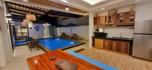 a kitchen and a swimming pool in a room at Sila Thai Pool Villa3 in Ao Nang Beach