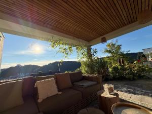 a couch on a patio with a view at Ferienchalets Riedenburg in Riedenburg