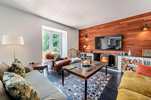 a living room with a couch and a fireplace at 4 Bed in Goodleigh oc-e29107 in Goodleigh