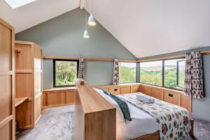 a bedroom with a bed and a large window at 4 Bed in Goodleigh oc-e29107 in Goodleigh