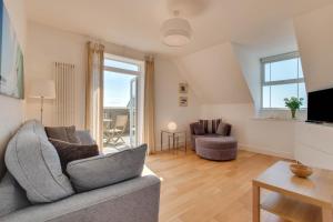 a living room with a couch and a tv at 1 Bed in Woolacombe oc-seablu in Woolacombe