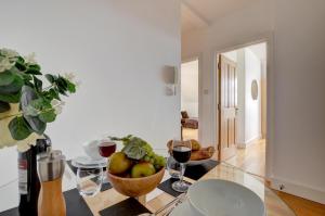 a room with a table with a bowl of fruit and wine glasses at 1 Bed in Woolacombe oc-seablu in Woolacombe