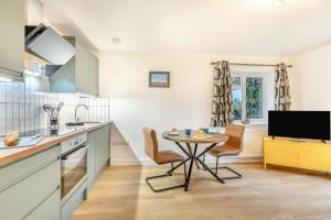 a kitchen with a table and a tv in it at 1 Bed in Ashcott oc-m33651 in Ashcott +9 photos