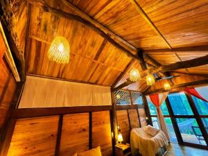 an attic room with a large wooden ceiling at Napong Ecolodge in Lung Co (1) +59 photos