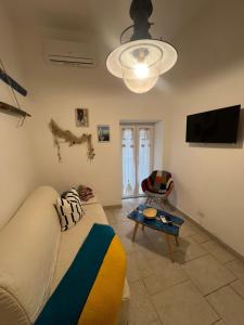 a living room with a couch and a flat screen tv at Porto Antico in Bari