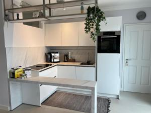a white kitchen with a table and a refrigerator at Ferienchalets Riedenburg in Riedenburg