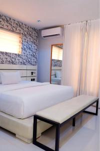 a bedroom with two beds and a bench in it at 2020 Apartment Katampe in Mama +29 photos