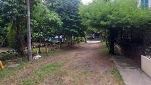 a dirt road with trees and a fence at Hotel Casa Franco in Cali
