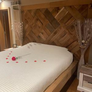 a white bed with red rose pedals on it at Apartment Design Suite in Jehanster +13 photos