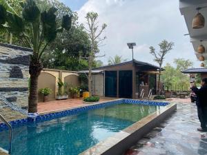 a pool in the backyard of a house with a resort at Your Home in Vũ Lâm