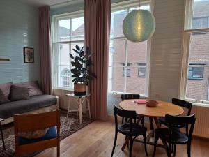 a living room with a table and a couch at Casa di Kola in Zutphen