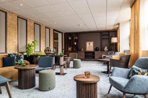 a lobby with couches and chairs and tables at Best Western Plus Skogshöjd in Södertälje