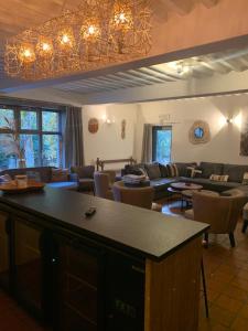 a large living room with a couch and a table at Gite Fond des Vaulx in Marche-en-Famenne