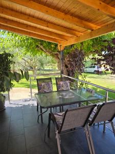 a green table and chairs on a patio at Eva House in Kanallákion