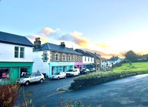 a group of cars parked on the side of a street at Secret Coast Getaway in Tighnabruaich