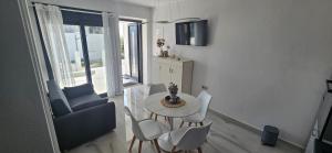 a small living room with a table and chairs at DaRo-Appartments in Asprovalta