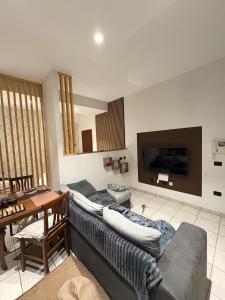 a living room with a couch and a tv at Residenza Europa in Budrio